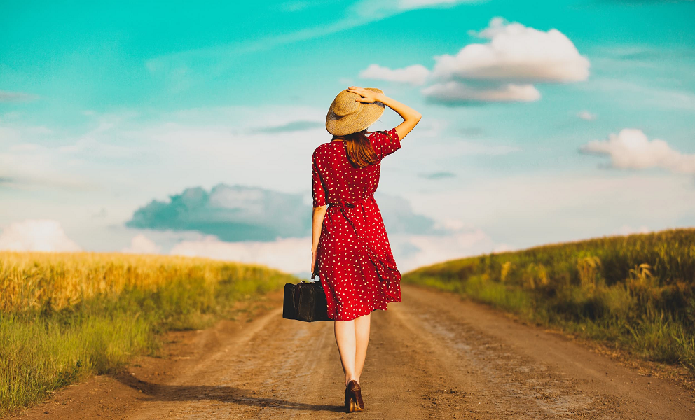 A woman wears a red dress with her back to the camera.